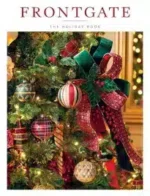 A high-end outdoor patio set featuring teak furniture and navy blue Sunbrella cushions from the Frontgate Catalog.